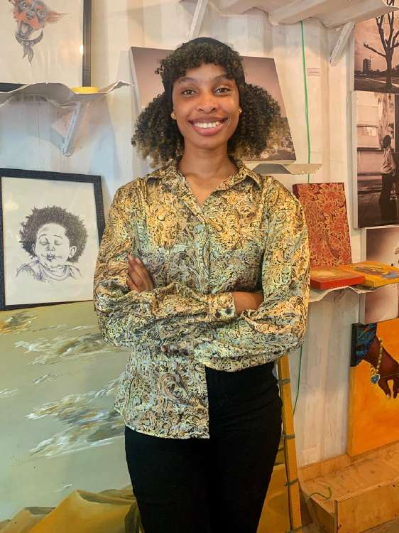 Mpembee Mary with works in the studio